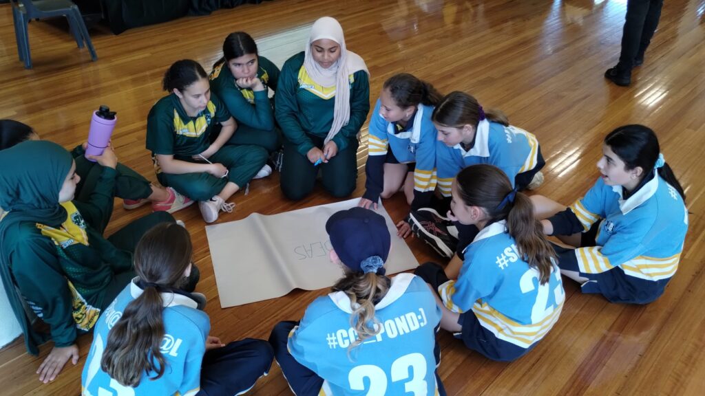 A small group of high school students from different cultural and religious backgrounds participate in groupwork together