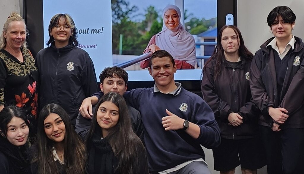 A multicultural group of high school students pose for a group photo together